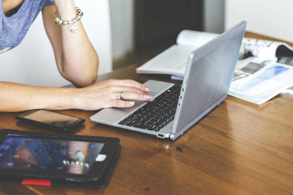 Mujer buscando información en su computadora sobre cómo optimizar contenido para SEO. 