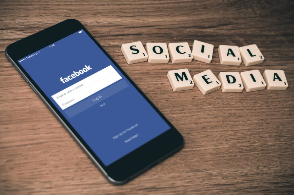 A stock image depicting a smartphone and the Facebook interface, one of the social networks where you could advertise your brand.
